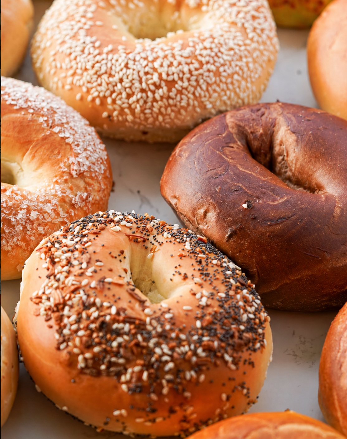 Stacks of fresh bagels in wholesale paper bags